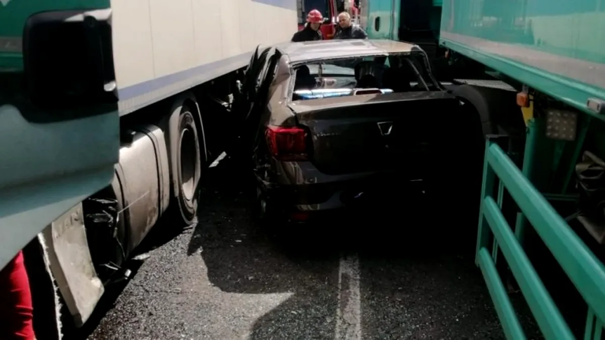 Dacia Logan, prinsă între două TIR-uri pe “Drumul morții” E85